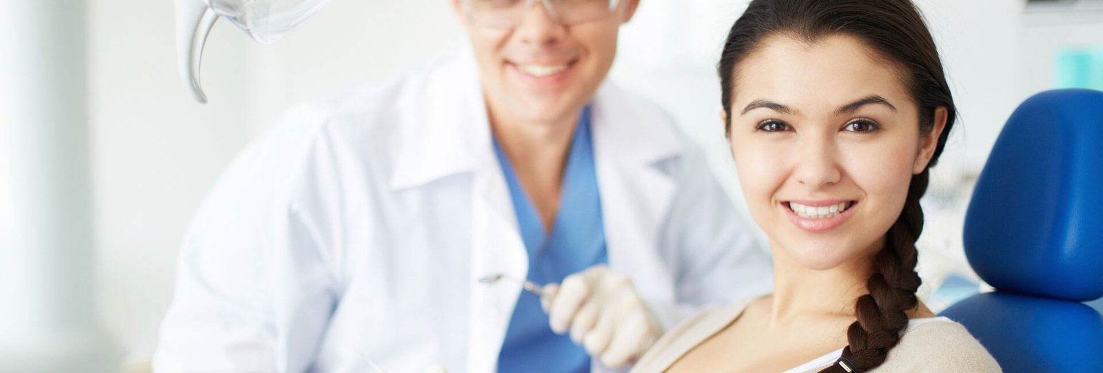 A beautiful young woman smiling at the dentist office